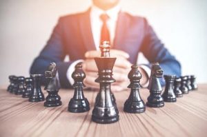 Business leader evaluating agile strategy on a dynamic marketplace chessboard