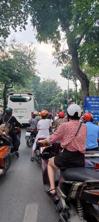 ge showing a street in Hanoi, Vietnam, highlighting the bustling motorbike traffic and urban environment