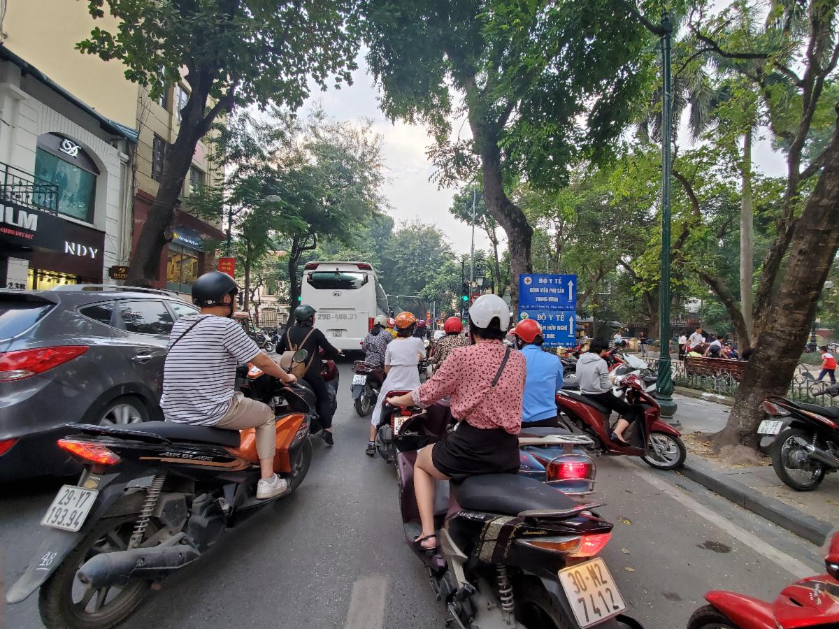 ge showing a street in Hanoi, Vietnam, highlighting the bustling motorbike traffic and urban environment